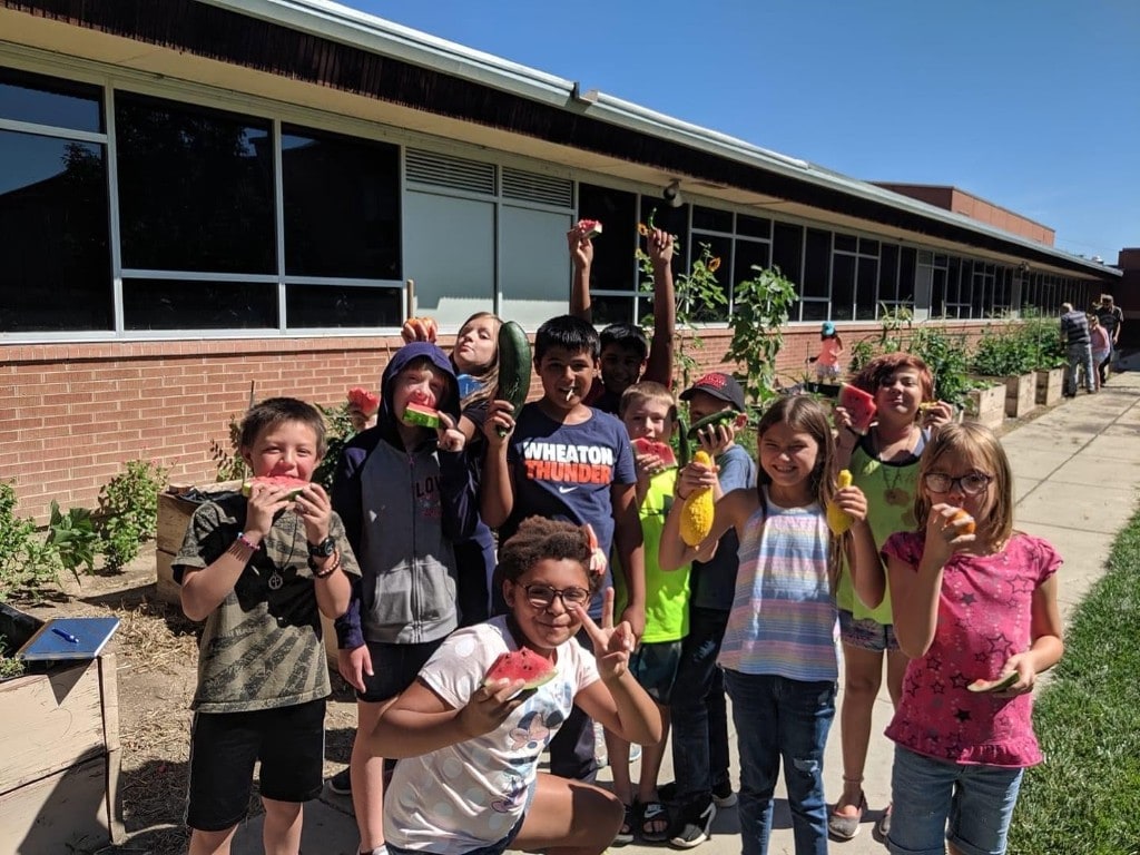 Green Thumb Initiative students celebrating a garden harvest in Southern Colorado